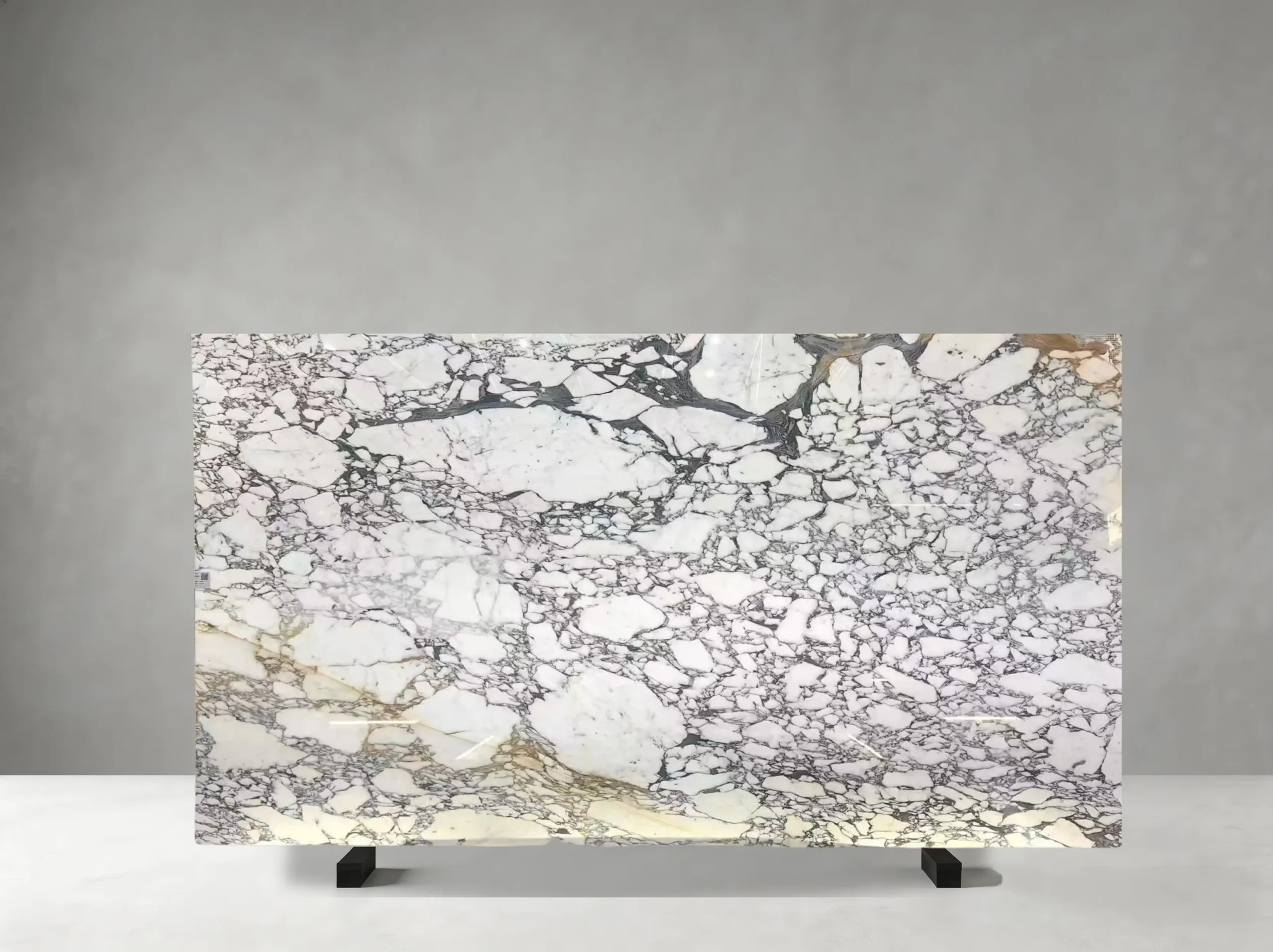 Bianco Arabescato Marble full slab showing white, pale grey and cool blue-grey tones with layered grey veining, fragmented mineral fields and occasional warm accents