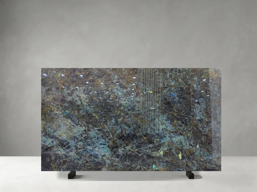 Blue Lemure Granite full slab showing blue-green, charcoal, silver and iridescent gold tones with dense crystalline texture with shifting blue and green labradorescent flashes