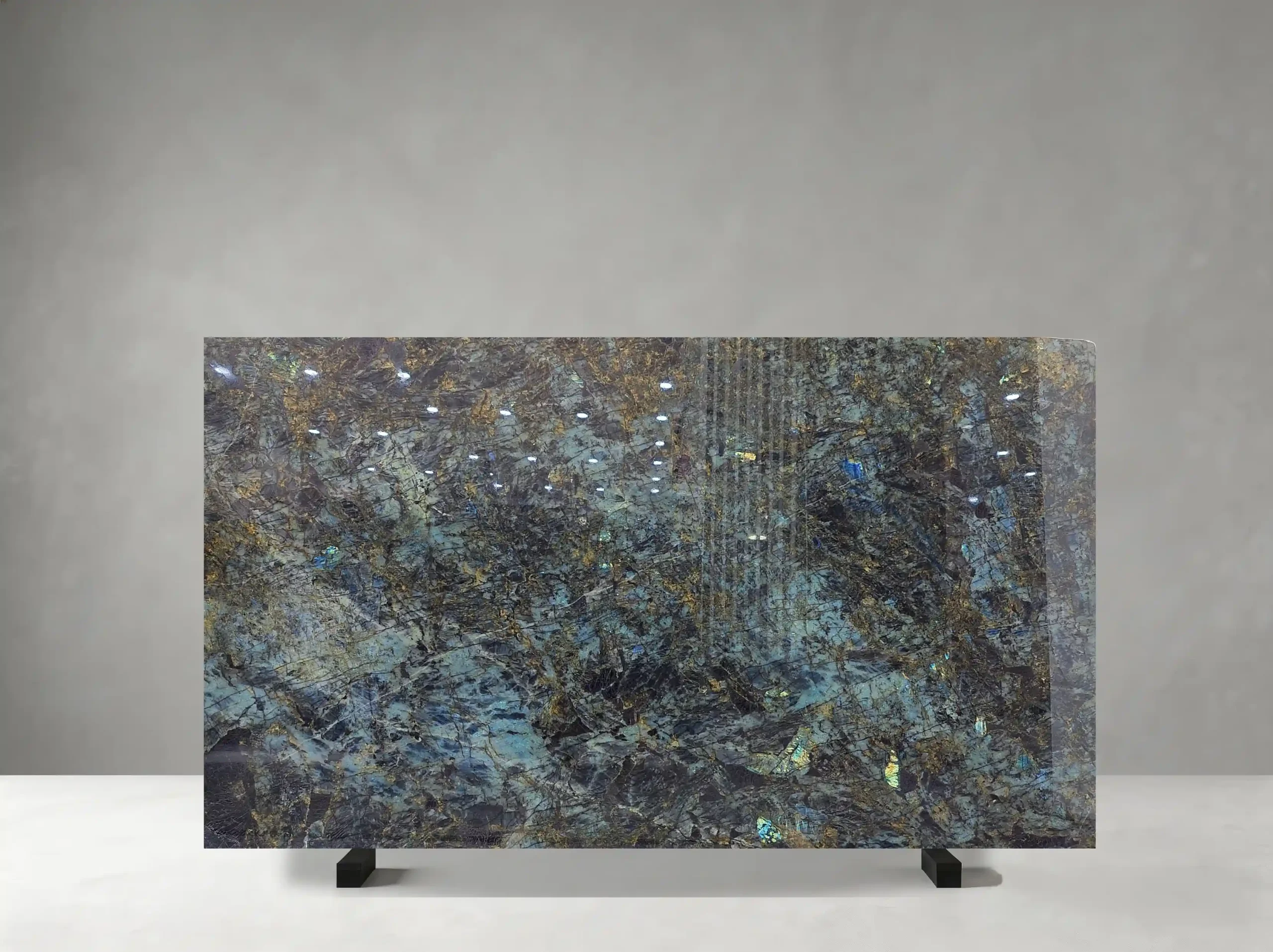 Blue Lemure Granite full slab showing blue-green, charcoal, silver and iridescent gold tones with dense crystalline texture with shifting blue and green labradorescent flashes