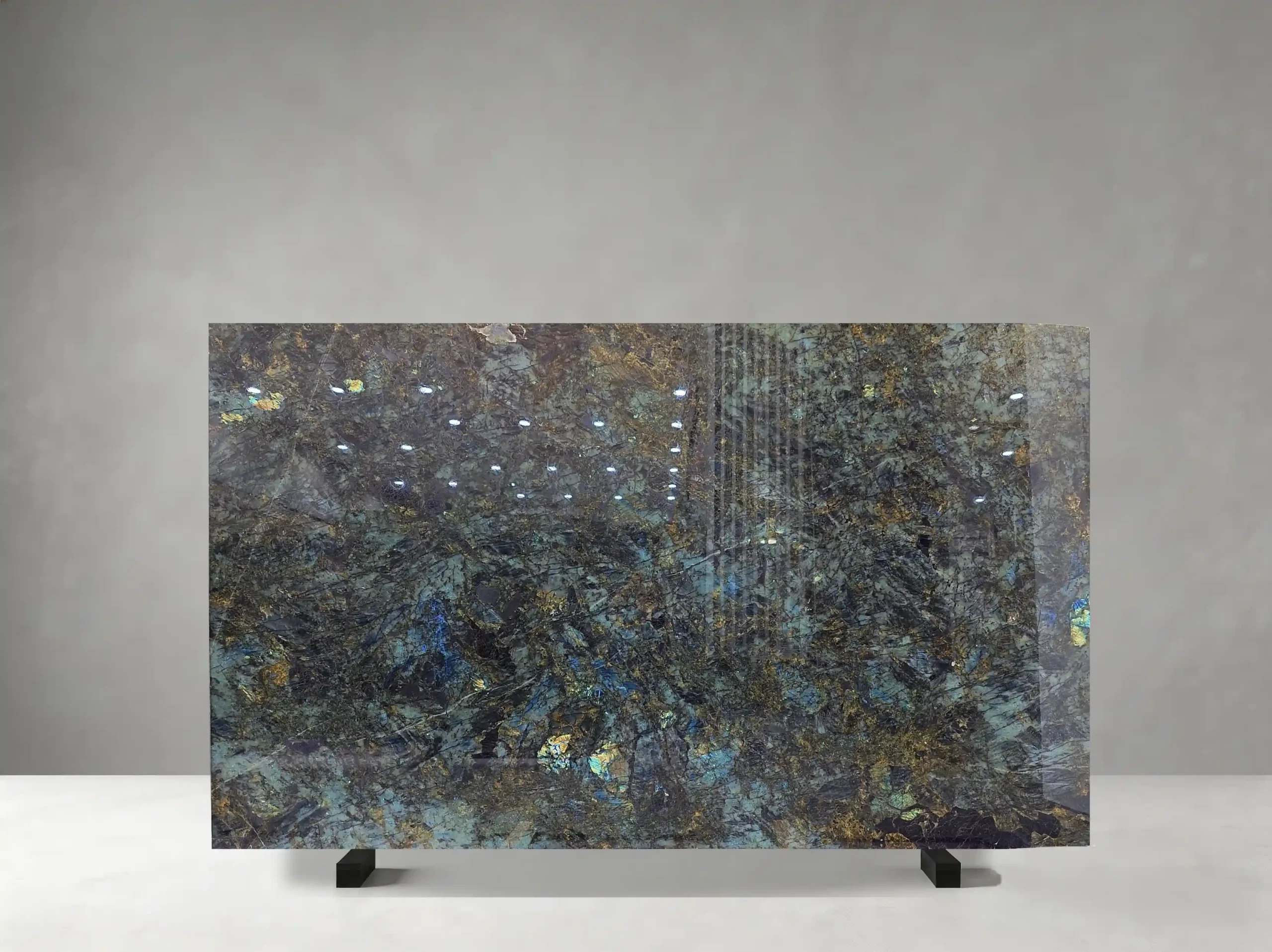 Blue Lemure Granite full slab showing blue-green, charcoal, silver and iridescent gold tones with dense crystalline texture with shifting blue and green labradorescent flashes