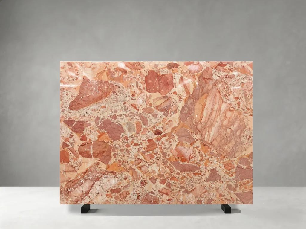 Breccia Perniche Marbre full slab showing coral, salmon, terracotta, cream and pale rose tones with angular brecciated fragments crossed by fine white and warm red mineral veins