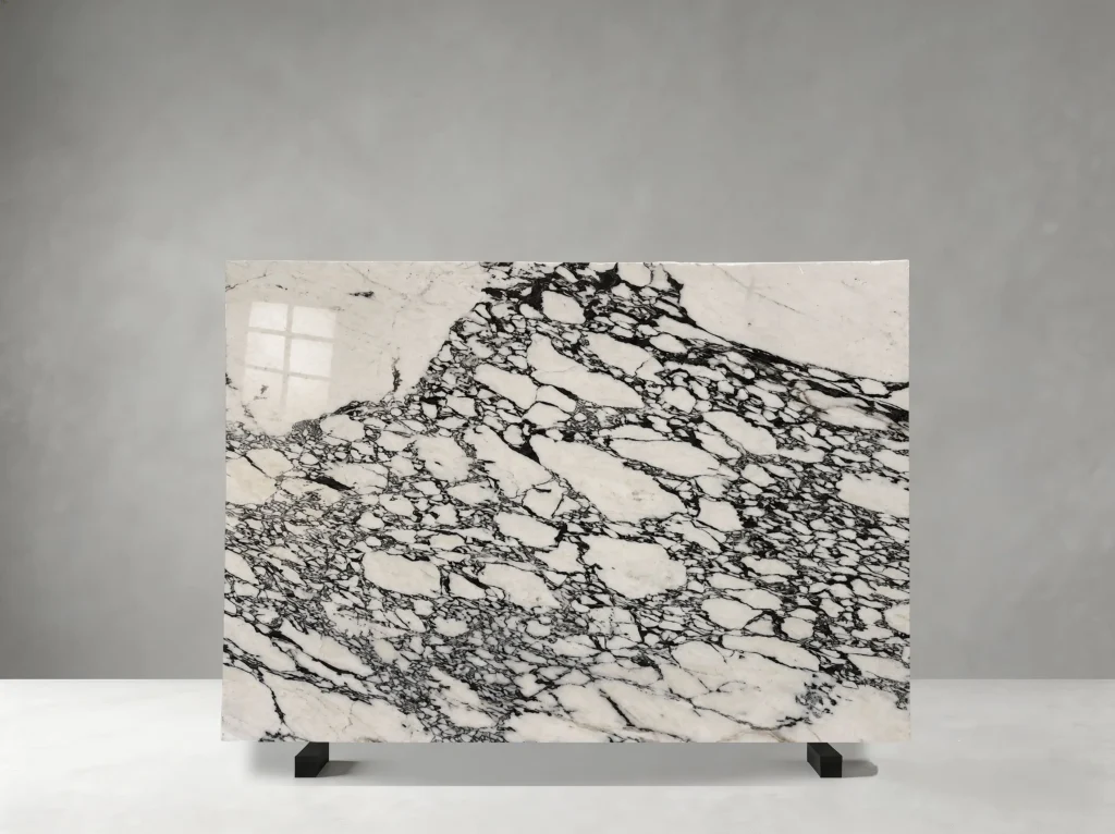 Bvlgari Marble full slab showing ivory white, pale cream, charcoal and black tones with bold fragmented white mineral fields held within a dense dark brecciated network