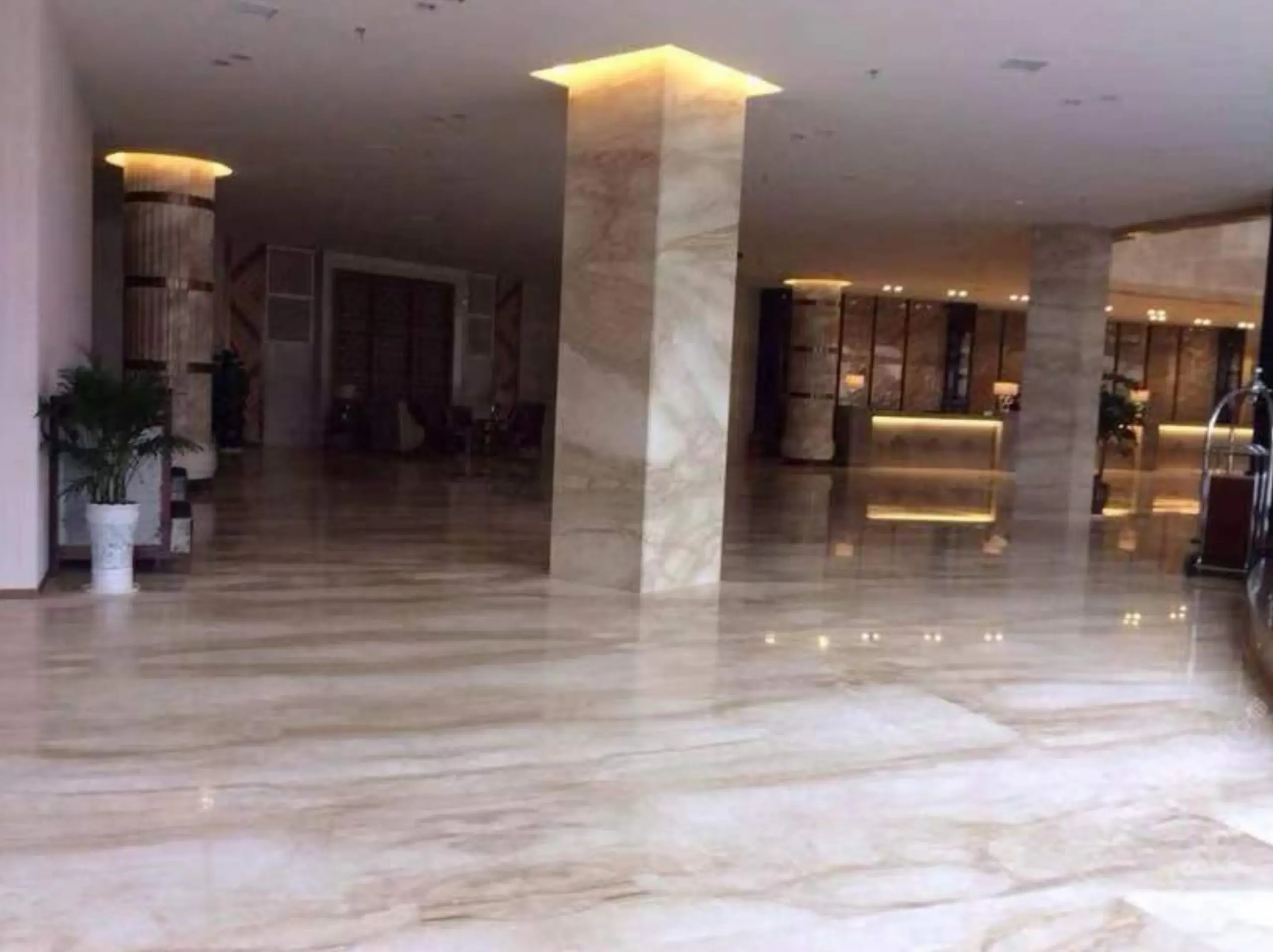 Daino Royal Marble hotel lobby flooring and columns with coordinated warm beige stone surfaces