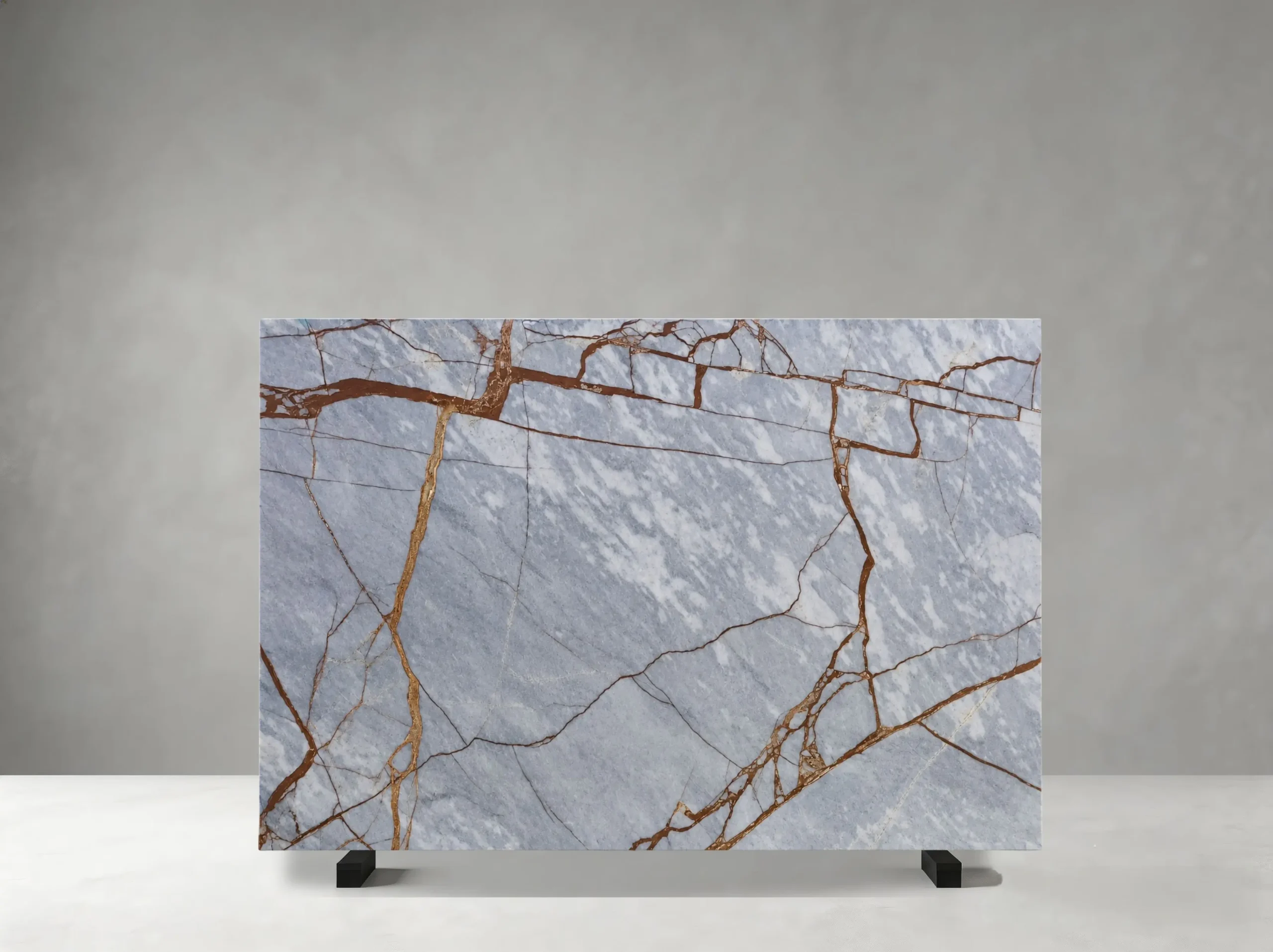 Deep River Marble full slab showing cool blue-grey, silver and pale grey tones with rust-red and copper linear veins crossing layered cloudy mineral movement
