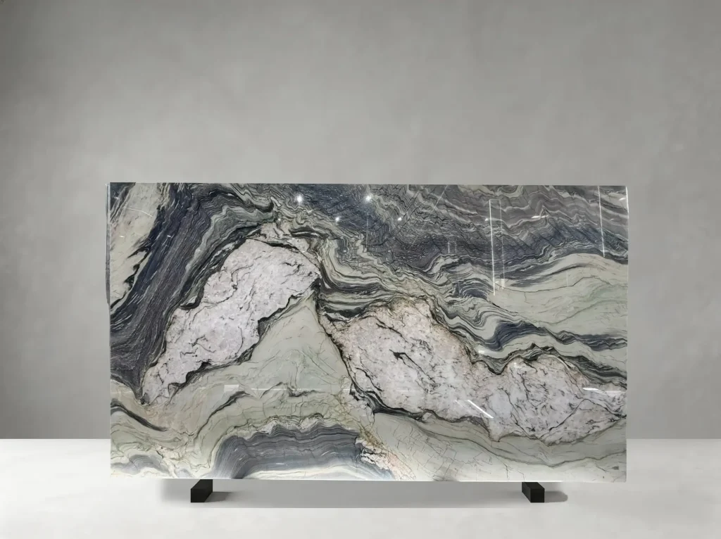 Fusion Blue Quartzite polished slab showing a striking blue-white field with navy waves and occasional warm accents