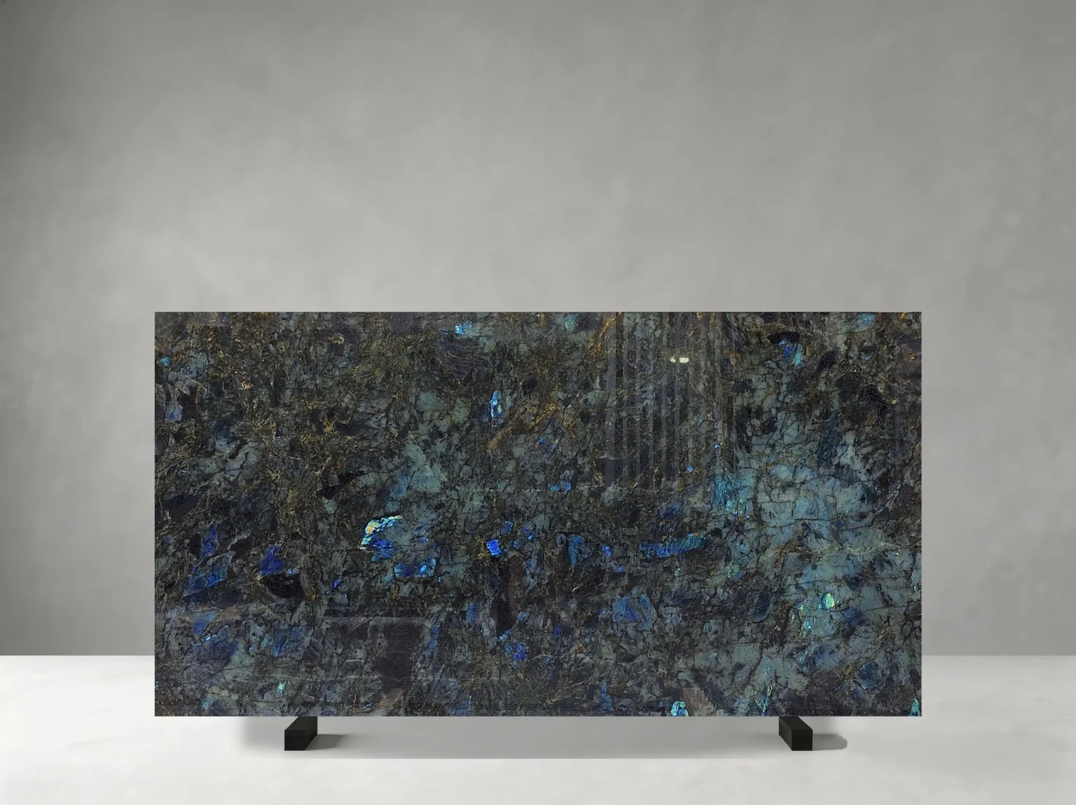 Madagascar Blue Granite full slab showing deep blue, blue-green, charcoal and silver tones with dense crystalline texture with scattered luminous blue mineral flashes