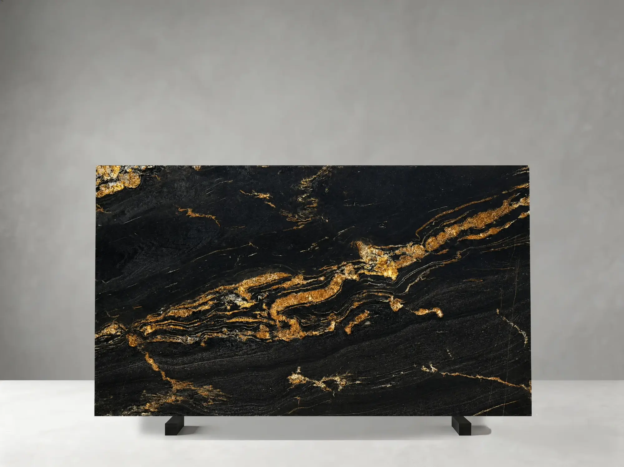 Magma Gold Granite polished slab showing a bold black surface swept by luminous gold and amber bands