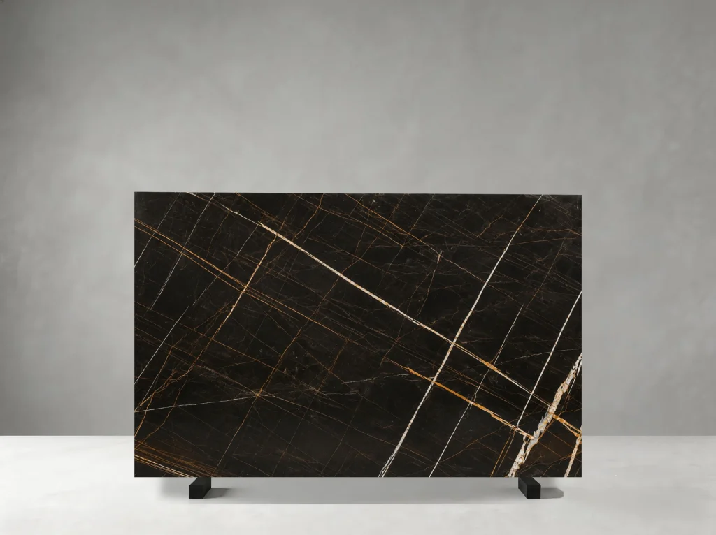Marbre Noir Gris Aziza Marble full slab showing deep black, charcoal and warm bronze-gold tones with fine intersecting golden veins over a compact dark background