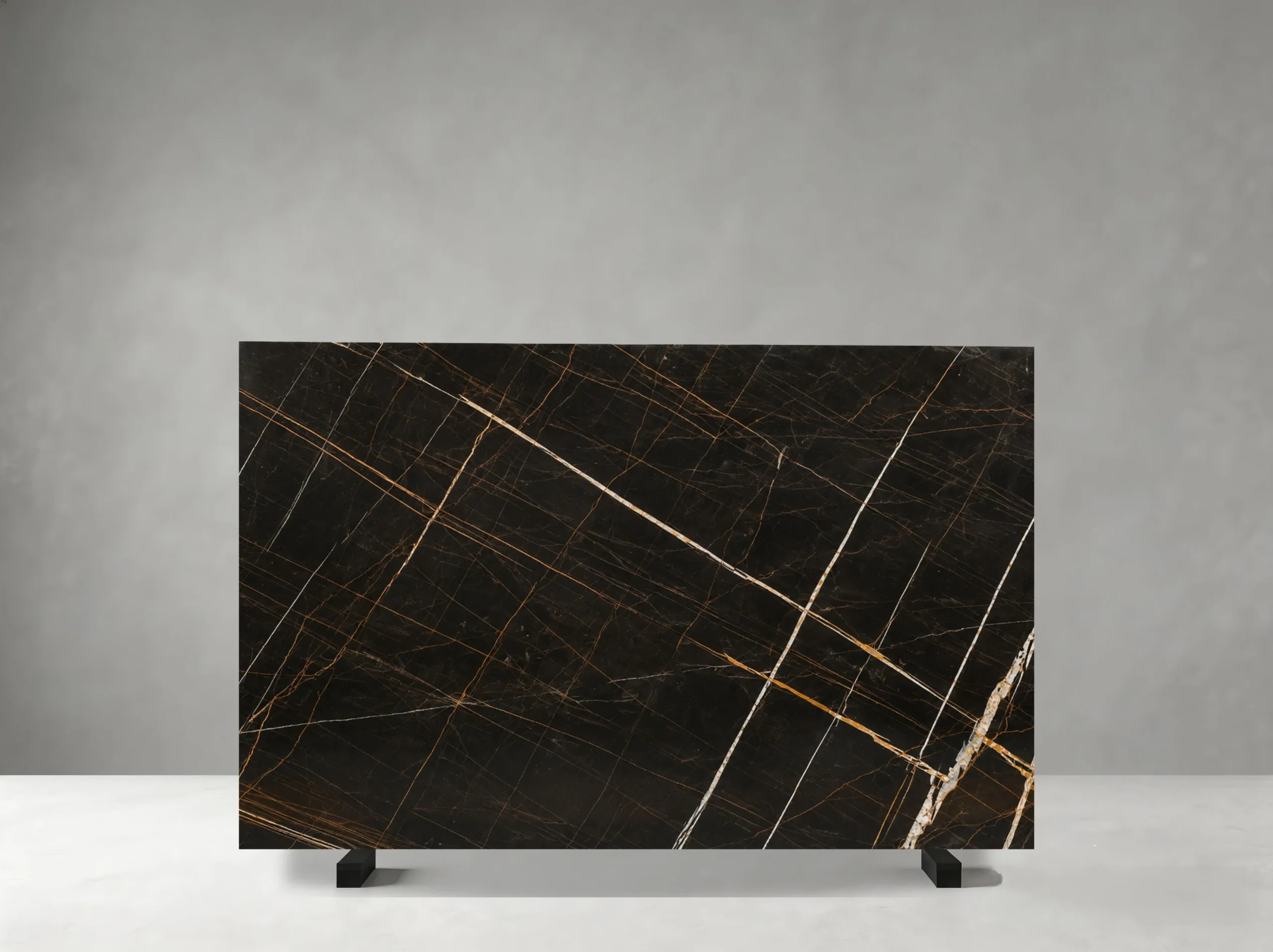 Marbre Noir Gris Aziza Marble full slab showing deep black, charcoal and warm bronze-gold tones with fine intersecting golden veins over a compact dark background