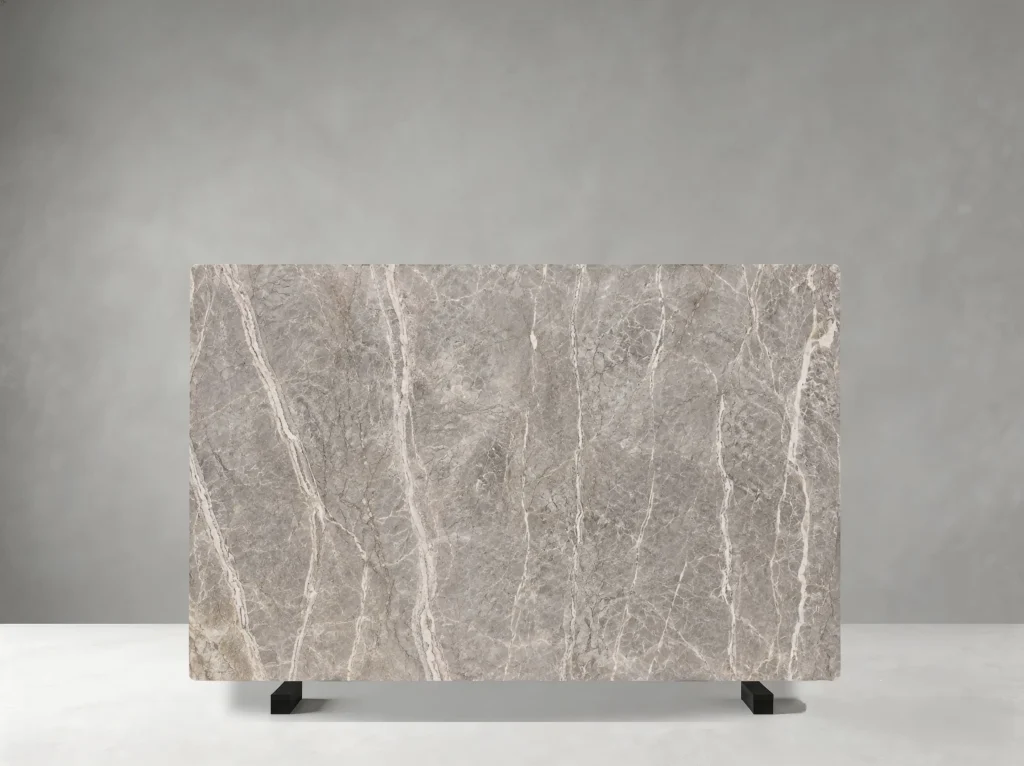 Marmi Etruscan Grigio full slab showing medium warm grey, taupe and pale cream tones with flowing white veins and broader cloud-like mineral transitions