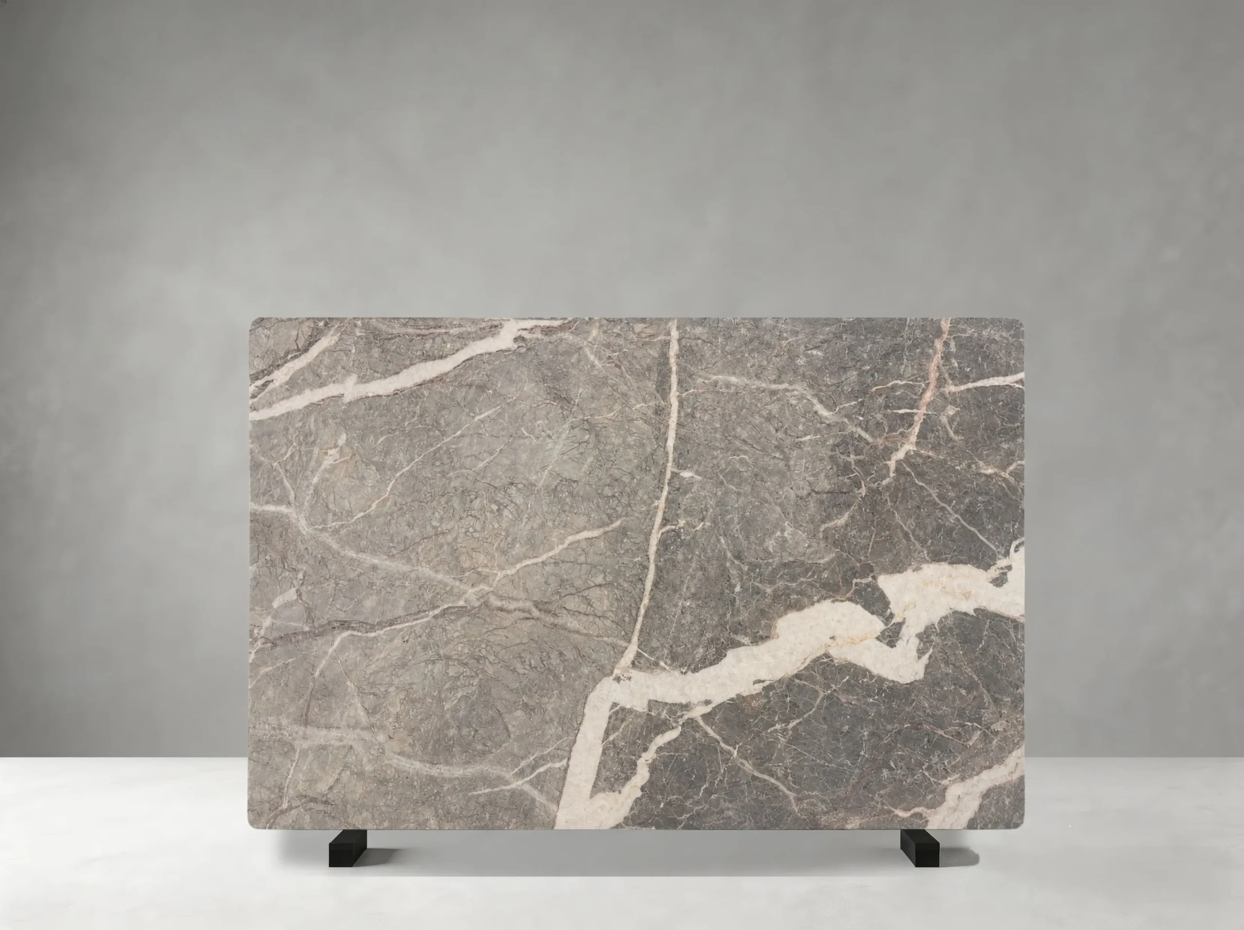Marmi Etruscan Grigio full slab showing medium warm grey, taupe and pale cream tones with flowing white veins and broader cloud-like mineral transitions