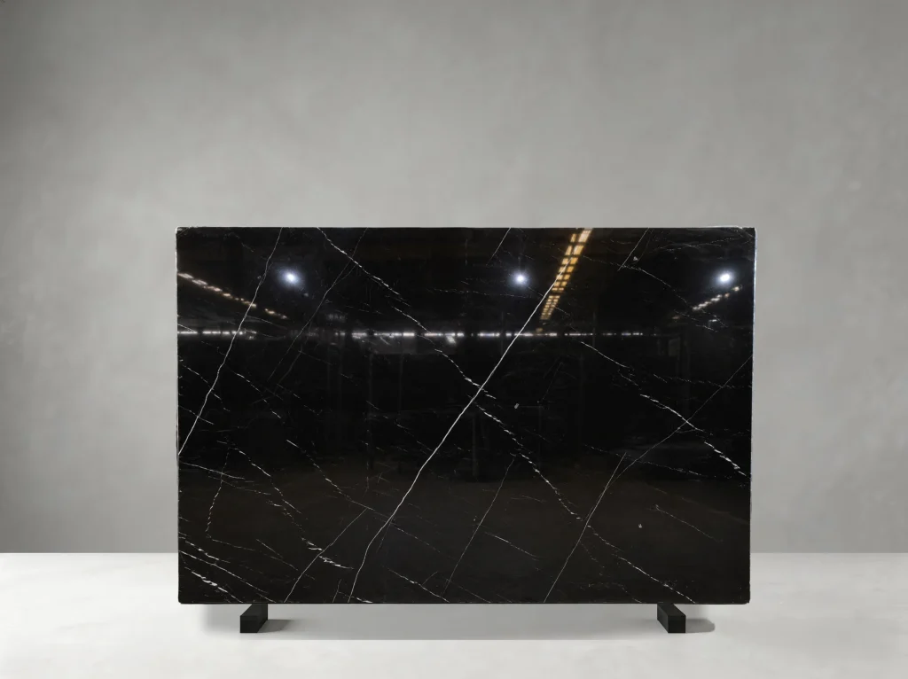 Nero Marquina Marble full slab showing jet black, charcoal and crisp white tones with thin irregular white veins with occasional stronger diagonal lines