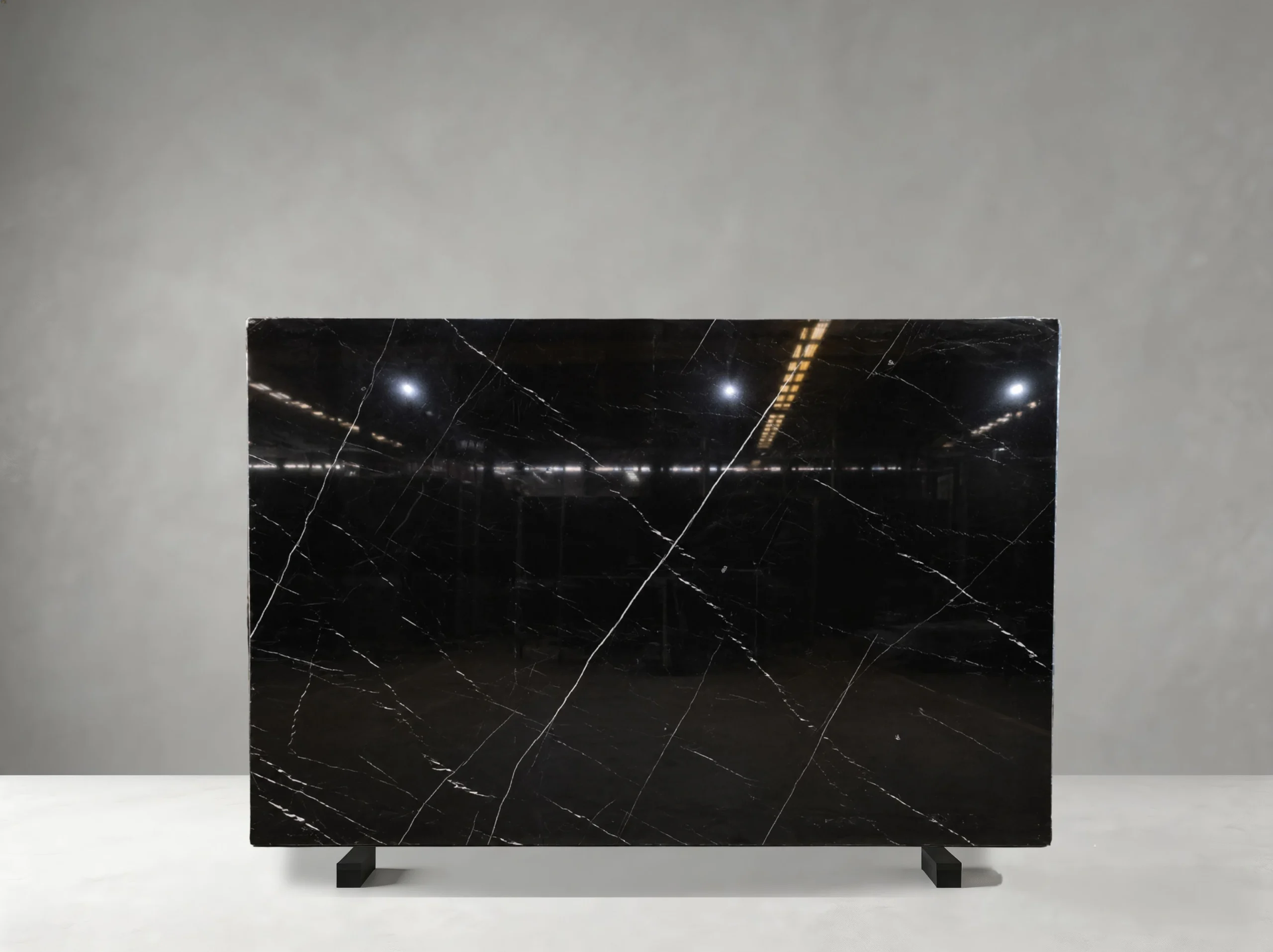 Nero Marquina Marble full slab showing jet black, charcoal and crisp white tones with thin irregular white veins with occasional stronger diagonal lines