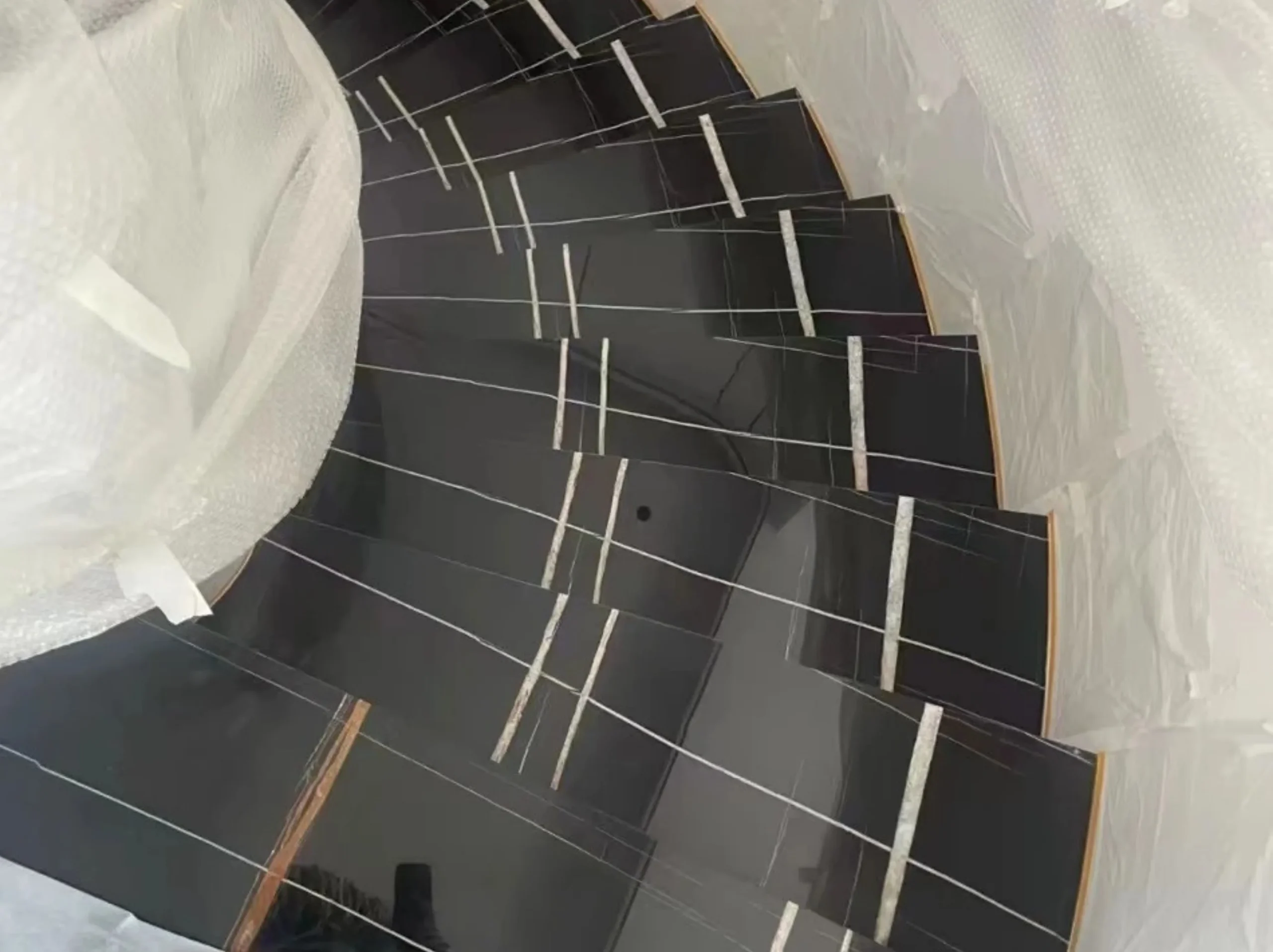 Noir Aziza Marble curved staircase treads and risers for a luxury interior project