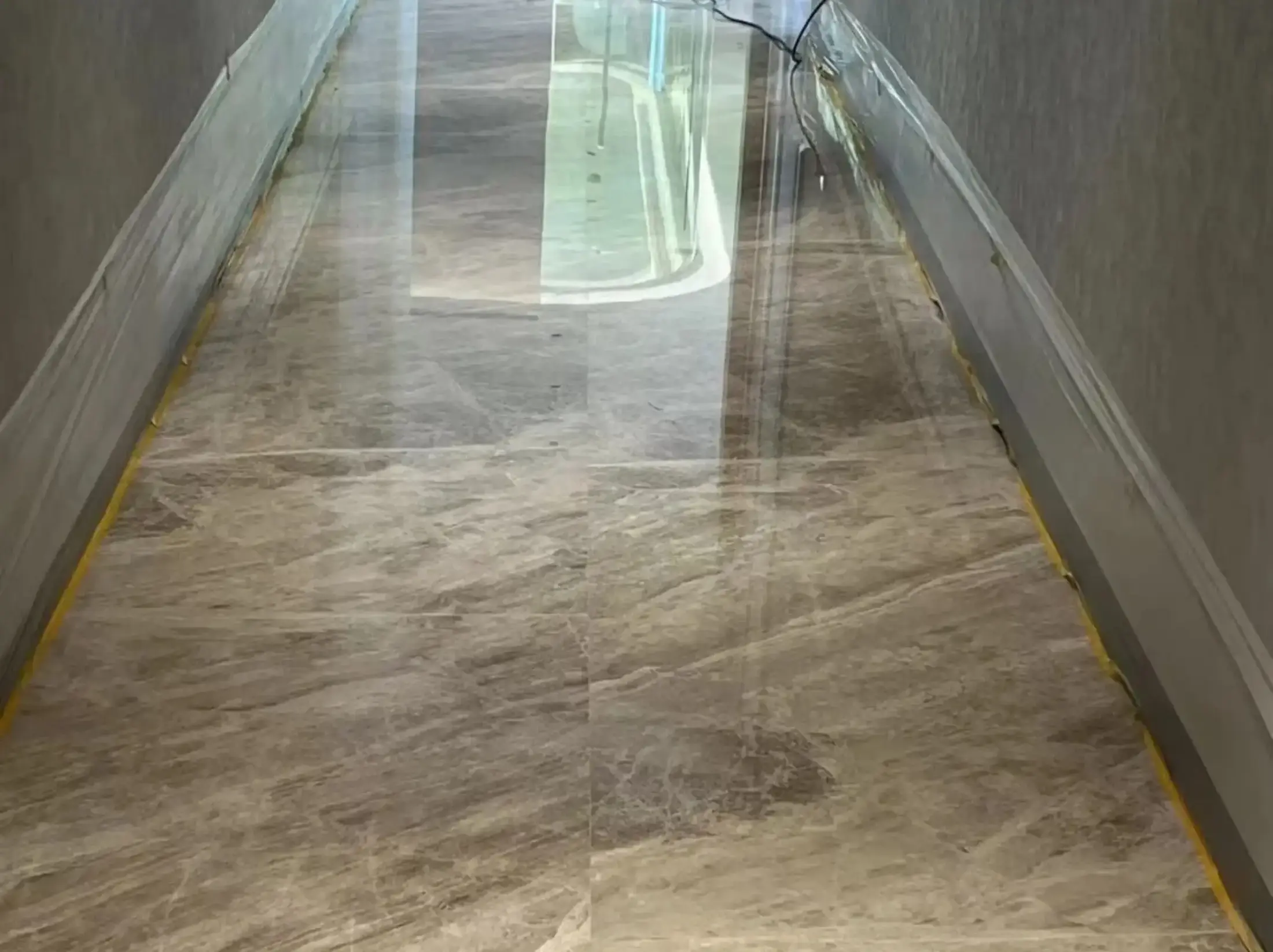Turkish Daino Marble corridor flooring with continuous beige grey directional pattern