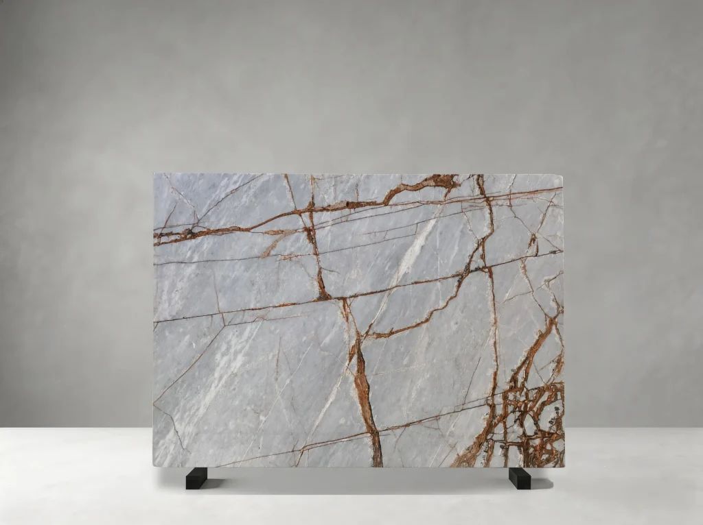 Winter River Marble full slab showing pale blue-grey, silver-white and warm rust tones with branching copper-red veins across broad icy mineral fields
