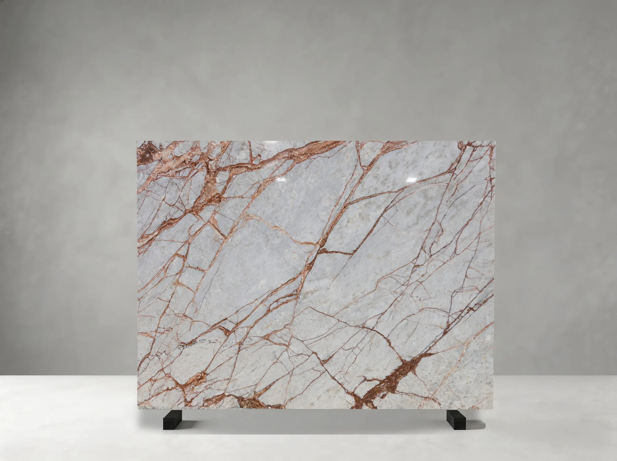 Winter River Marble full slab showing pale blue-grey, silver-white and warm rust tones with branching copper-red veins across broad icy mineral fields